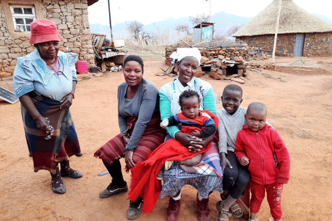 Grandmothers with grandchildren outside in Lesotho